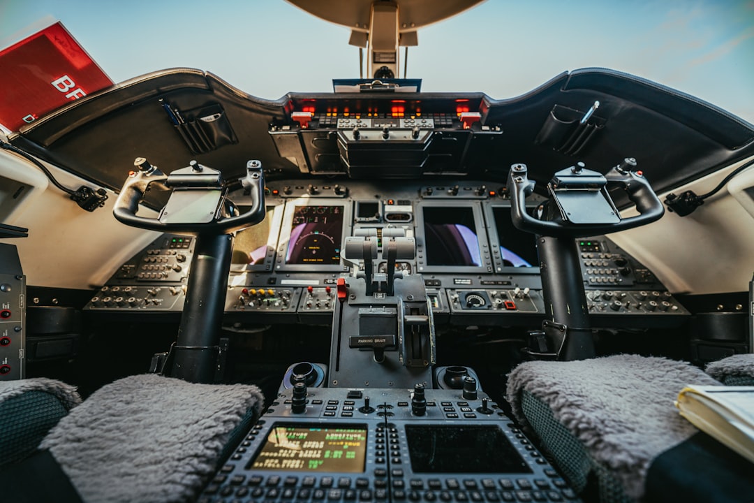 A collection of essential gear and equipment for private jet pilots, including flight bags, headsets, and navigation tools, arranged neatly on a cockpit table.